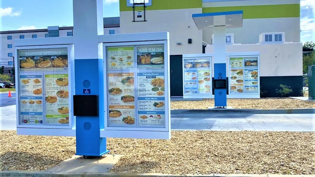 A photograph of two drive-thru menu boards at Captain D's.