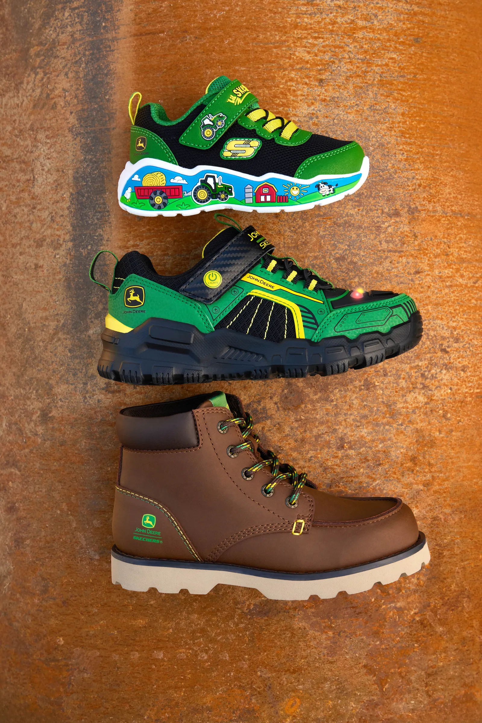 Three shoes lying on their sides in a line with Skechers and John Deere branding.