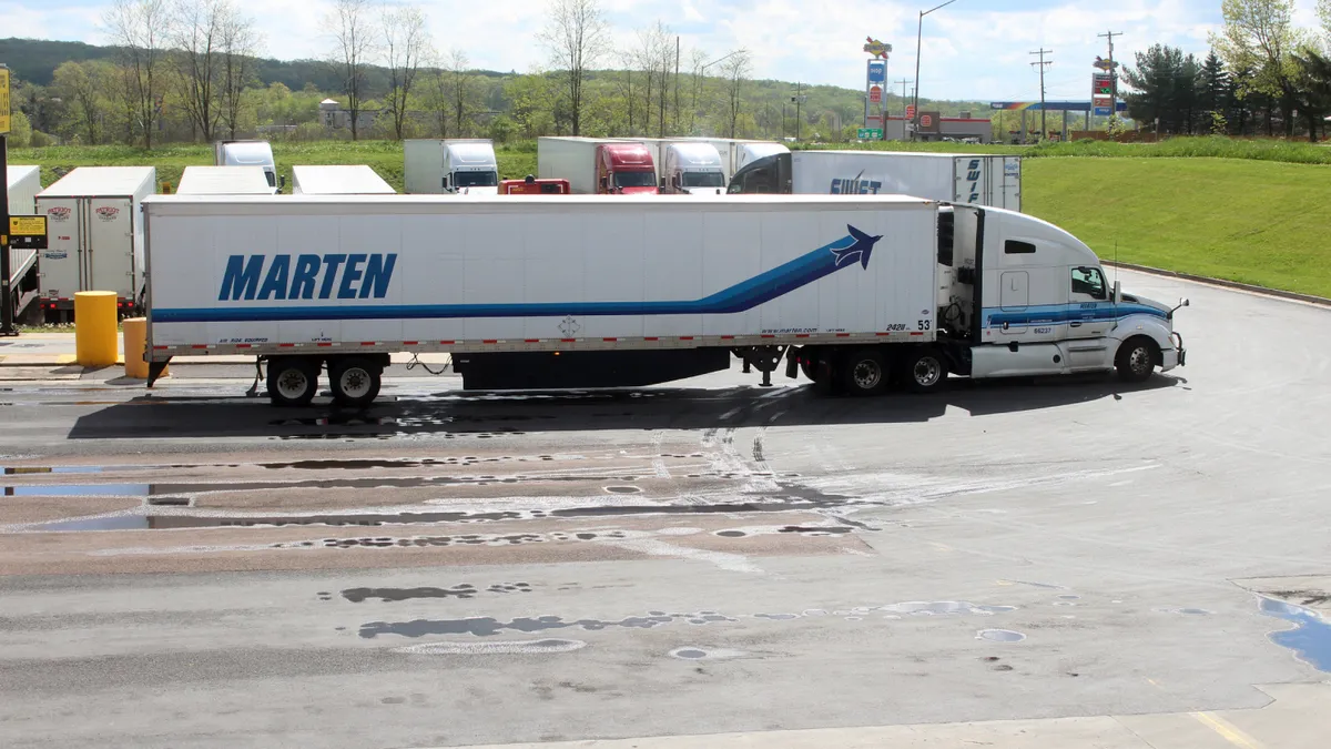 A Marten Transport tractor-trailer pulls into a truck parking lot in western Maryland in May 2024.