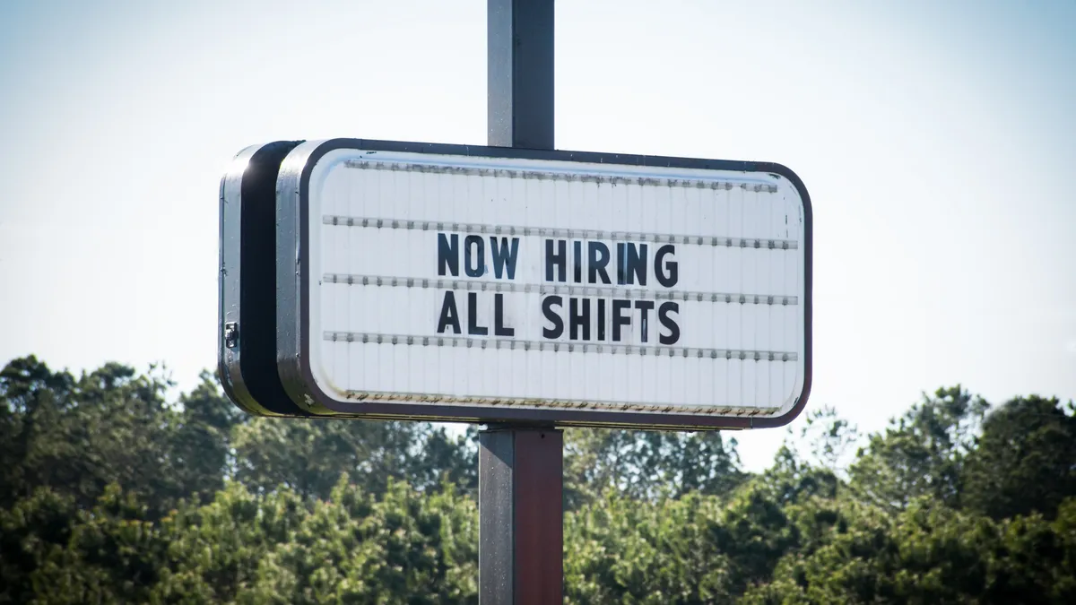 Now Hiring All Shifts Sign. A business openly advertises work opportunities.