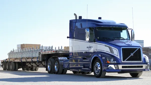 A blue and silver truck with the Searcy Trucking logo.