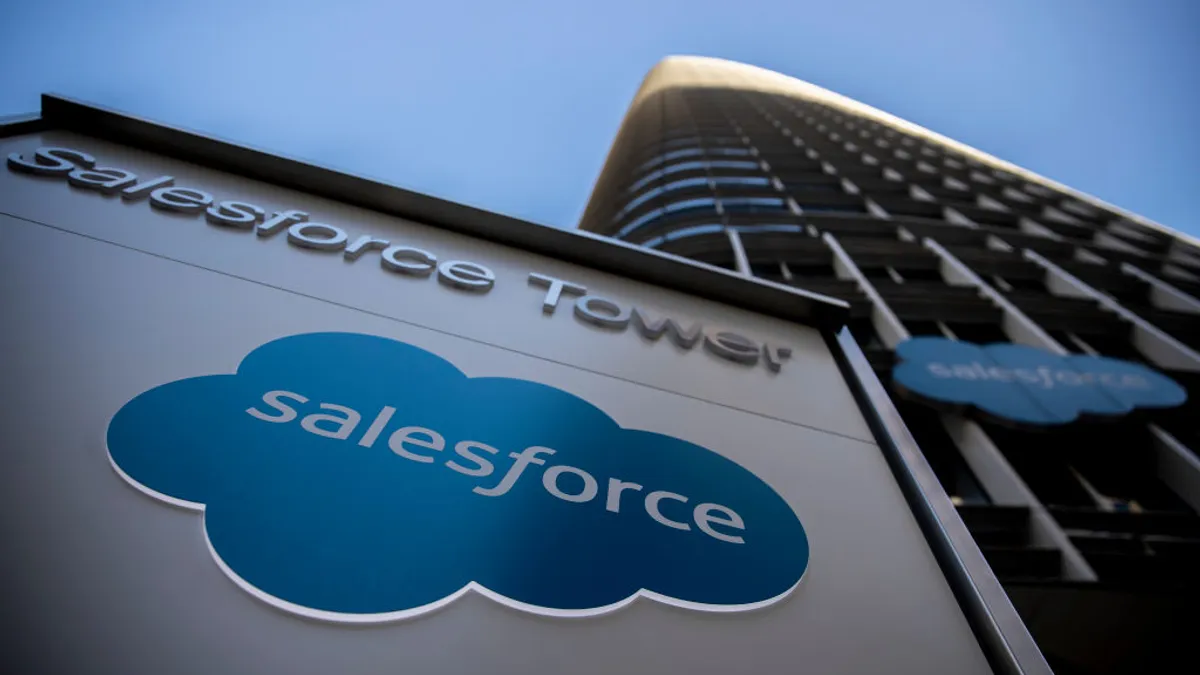 corporate signage bearing the Salesforce logo in front of a towering skyscraper