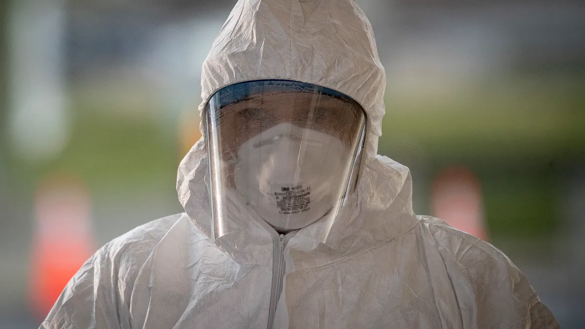 A medical technician pauses between patients at a COVID-19 Community-Based Testing Site at the PNC Bank Arts Center in Holmdel, N.J., March 23, 2020. The testing site, established in partnership with