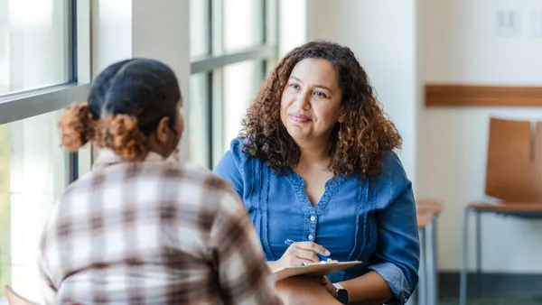 Two women sitting on a table and chatting