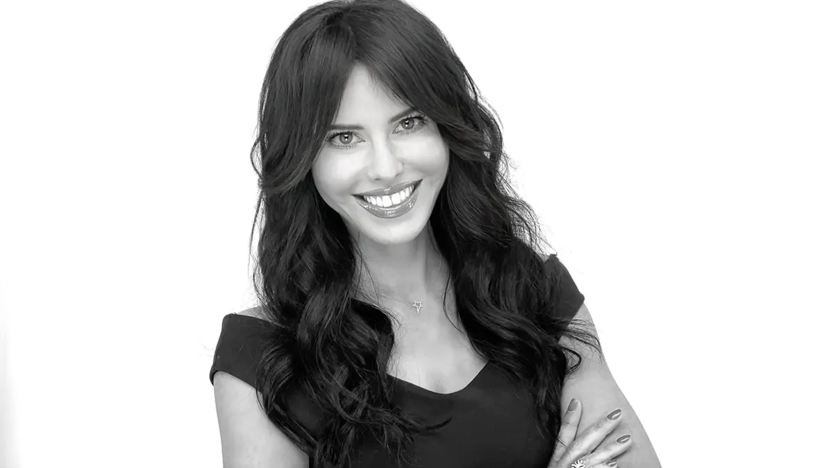 Eva Erdmann is pictured against a white back drop in black and white for a professional headshot.