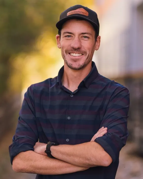 Headshot of a man with a hat.