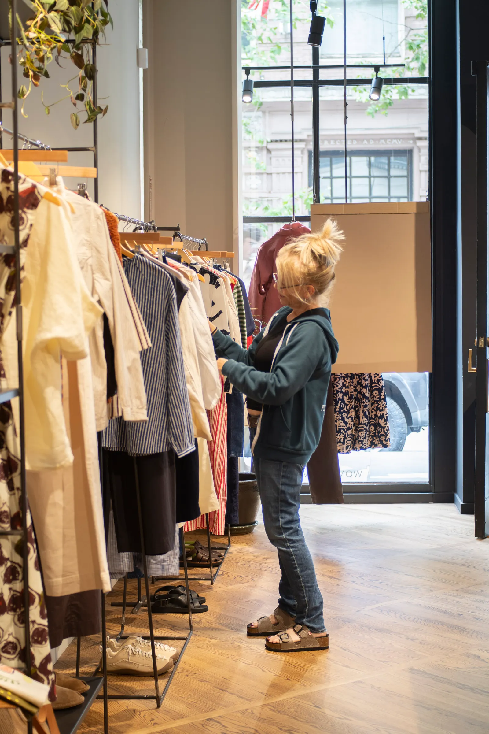 A person shopping at an apparel store.