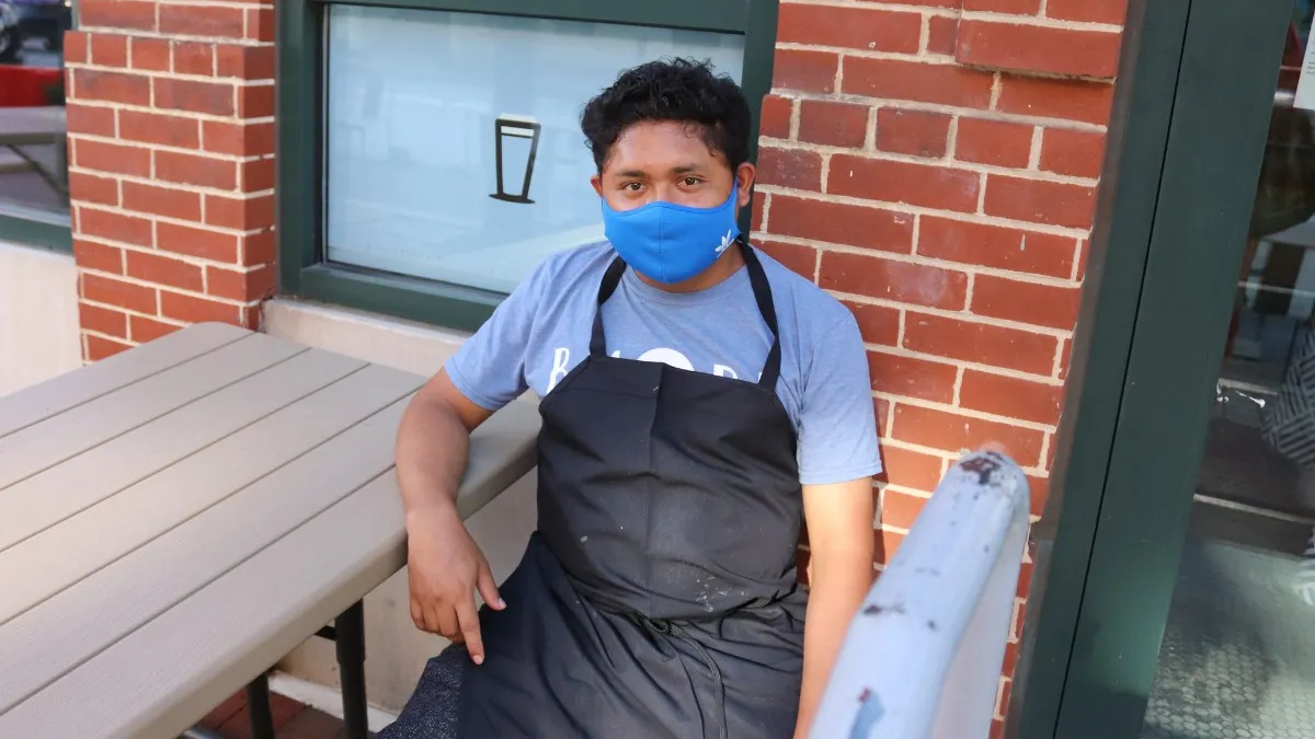 A masked employee at DOOBY's Korean Inspired Cafe in Baltimore, Maryland