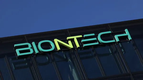 A BioNTech logo hangs on the side of an office building.