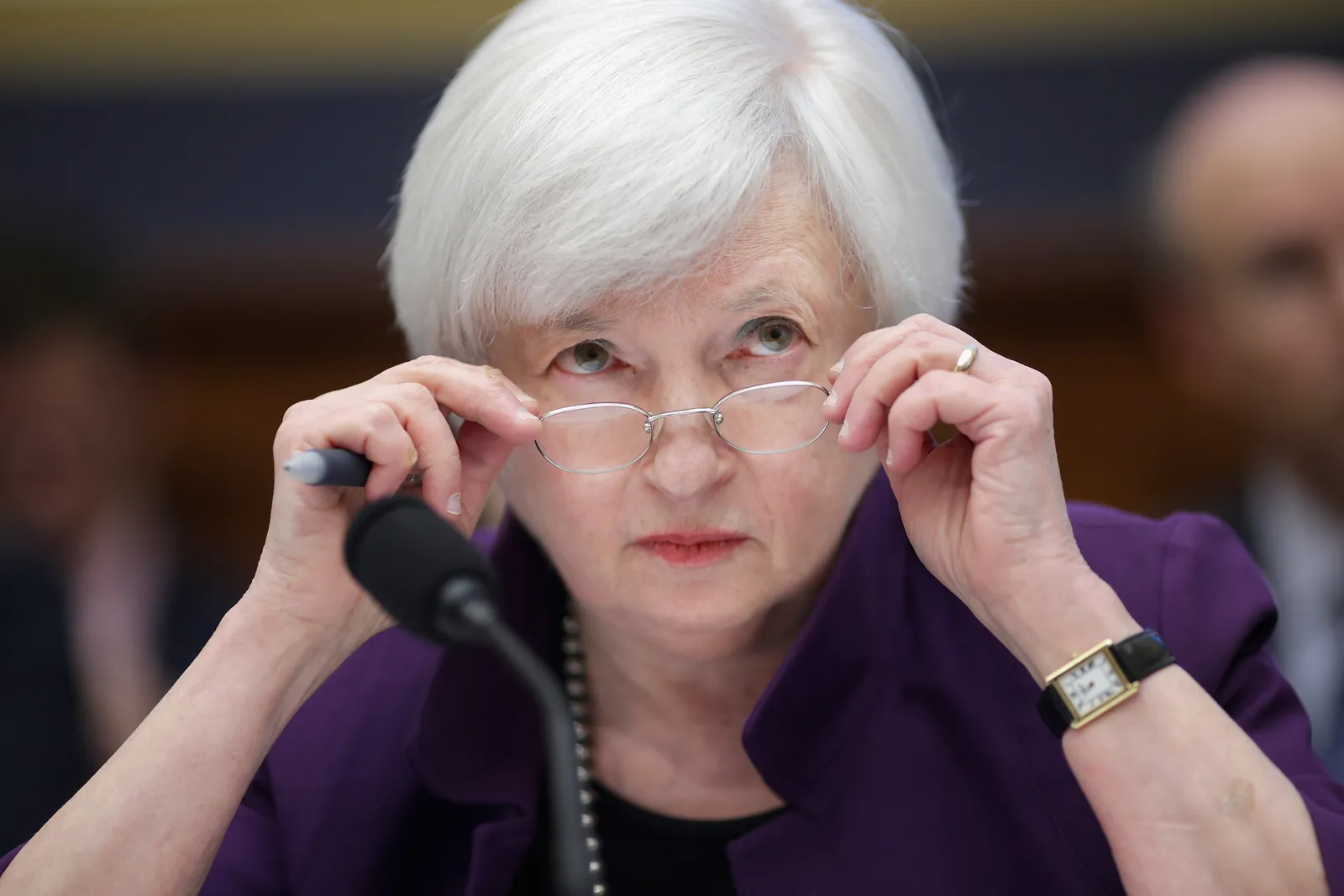 Treasury Secreatry Janet Yellen peers behind her glasses on Capitol Hill.