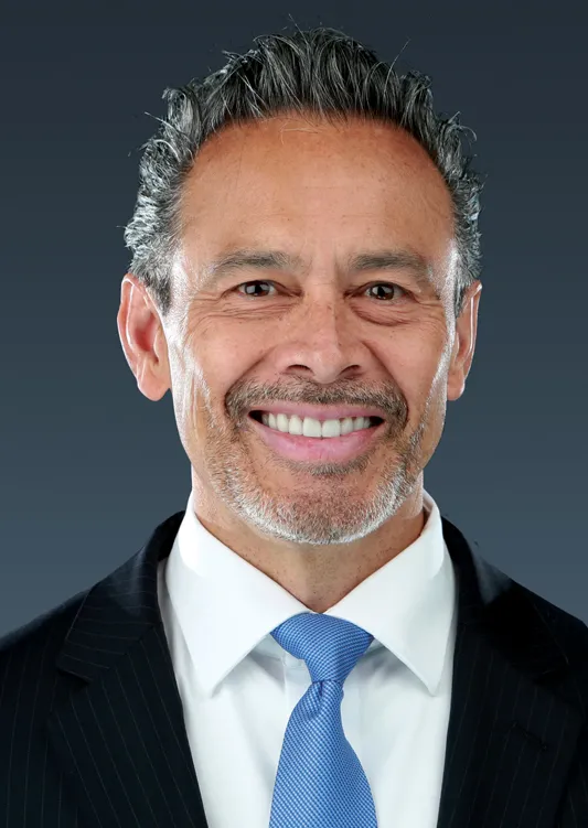 Headshot of a man in a suit.