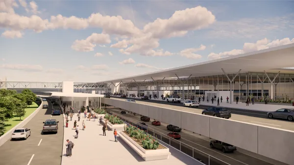 Multi-level airport building with a walkway and space for cars.