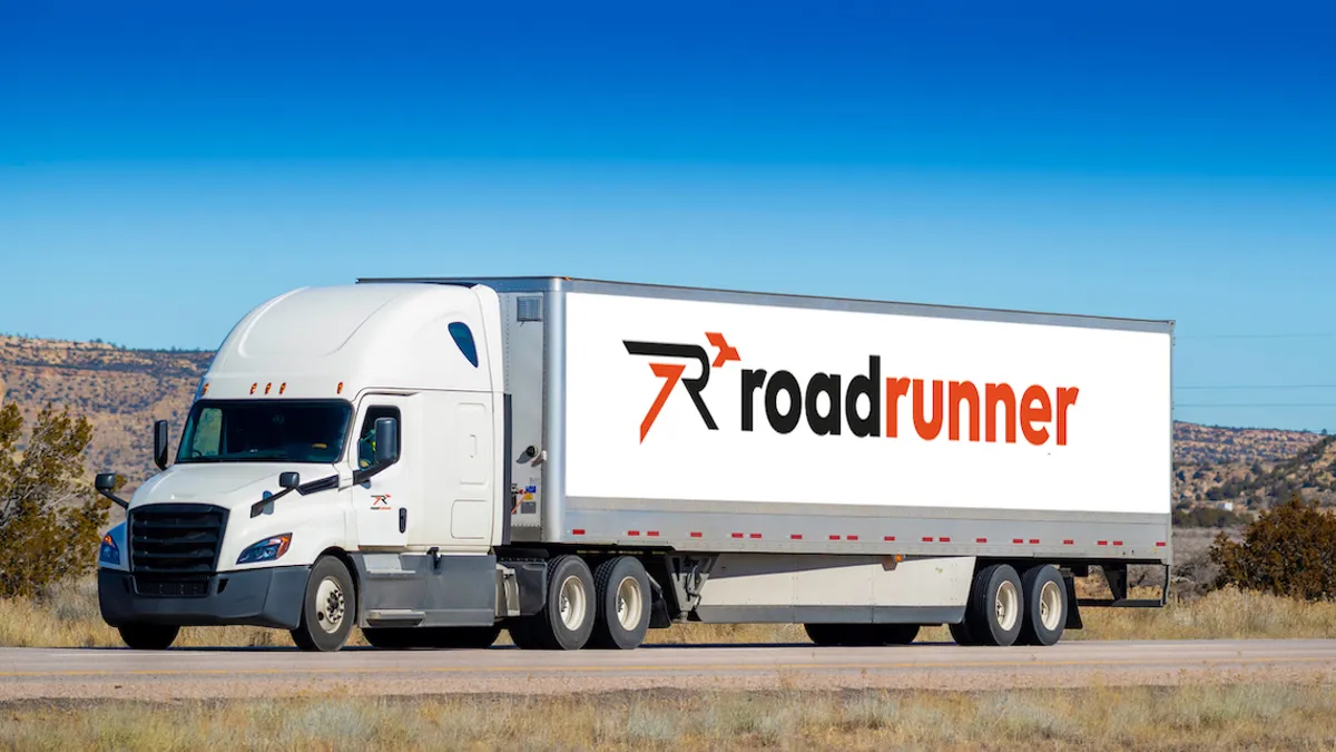 A Roadrunner truck on the road.