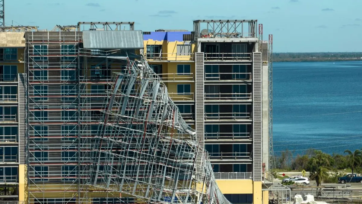 Aerial view of ruined by hurricane Ian construction scaffolding on high apartment building site