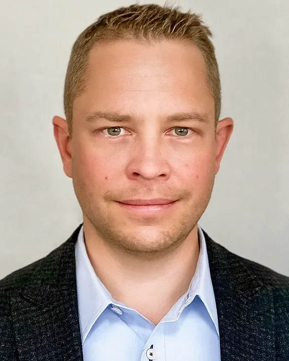 A headshot of Ryan Kunisch