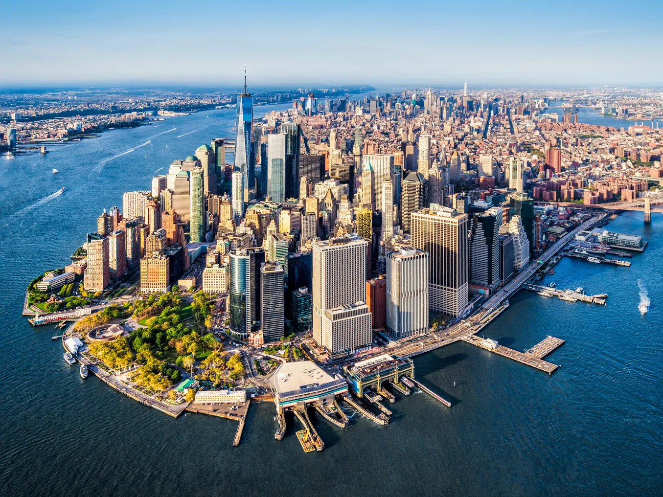 Aerial shot of skyscrapers and city buildings surrounded by water