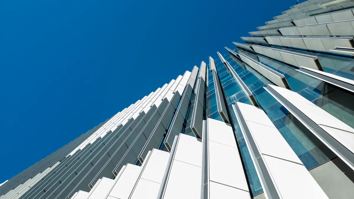 A smart building moves exterior building shades to control heat and energy usage within the interior.