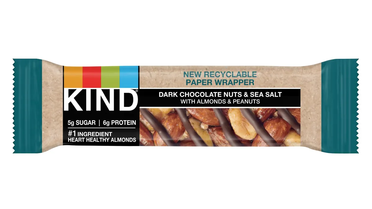 A Kind snack bar that has messaging on the label indicating the new paper wrapper is recyclable.