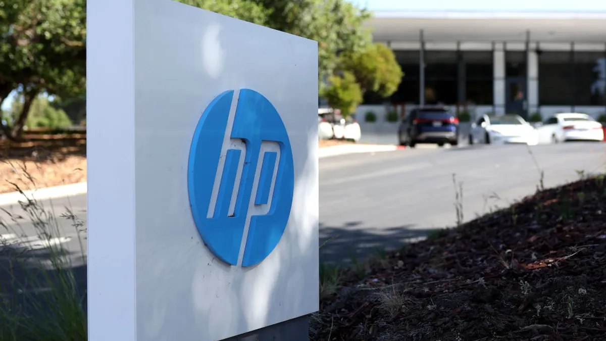 A sign with the HP logo is posted in front of a Hewlett-Packard office