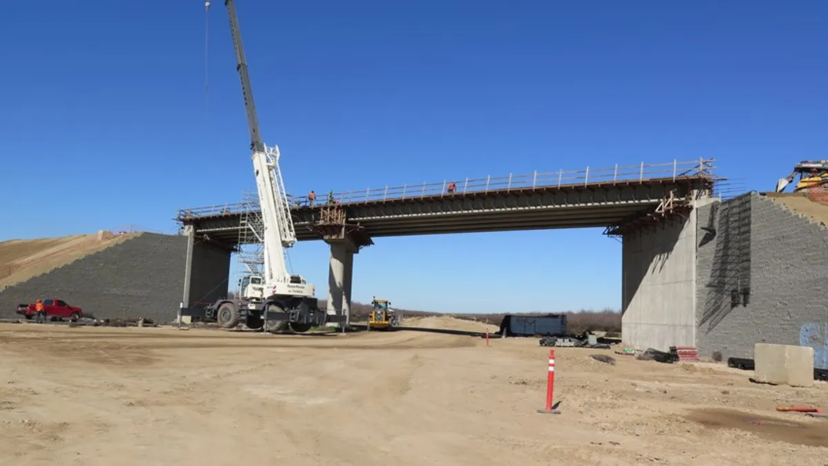 At the edge of Madera County just north of the San Joaquin River Viaduct, crews continue to haul in embankment/dirt to form the mechanically stabilized earth (MSE) walls of the future overcrossing at