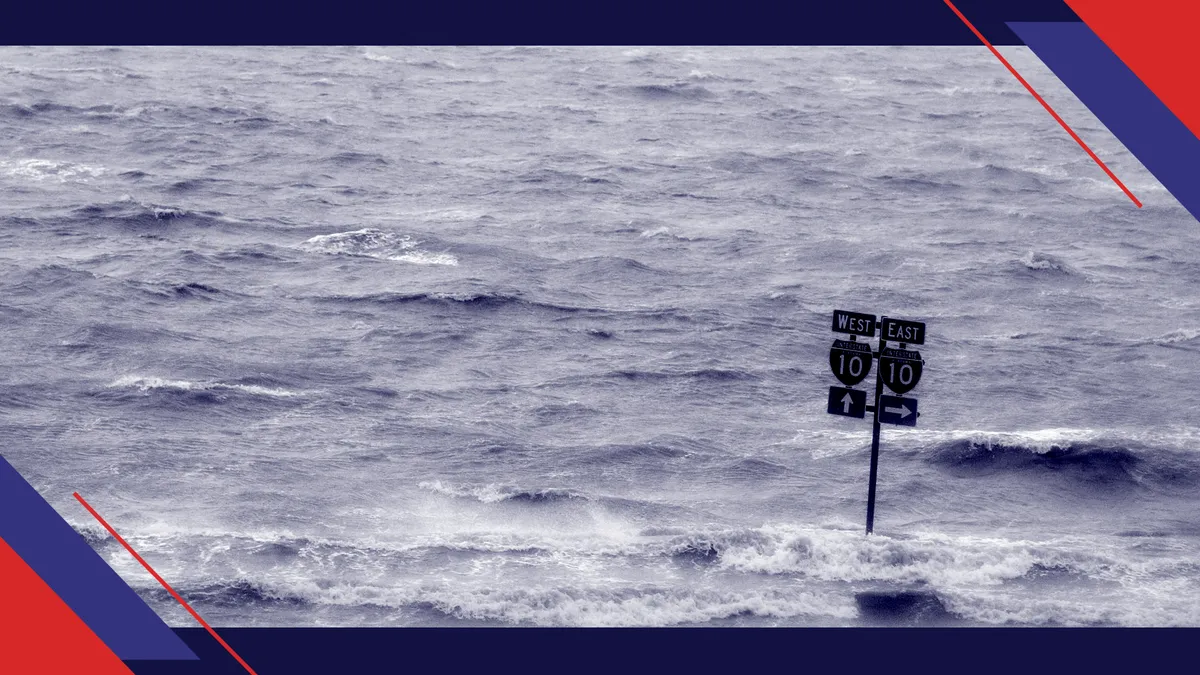 A sign directing drivers to the on ramp for Highway 10 sits half submerged in flood waters from the Gulf of Mexico after Hurricane Ivan passed through early September 16, 2004 in Mobile, Alabama