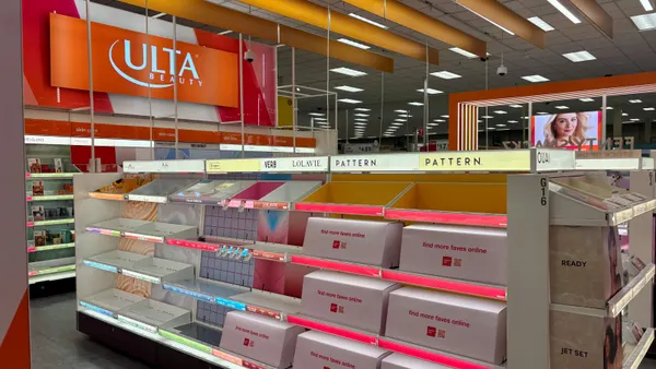 Empty white and orange retail shelves with the Ulta logo above