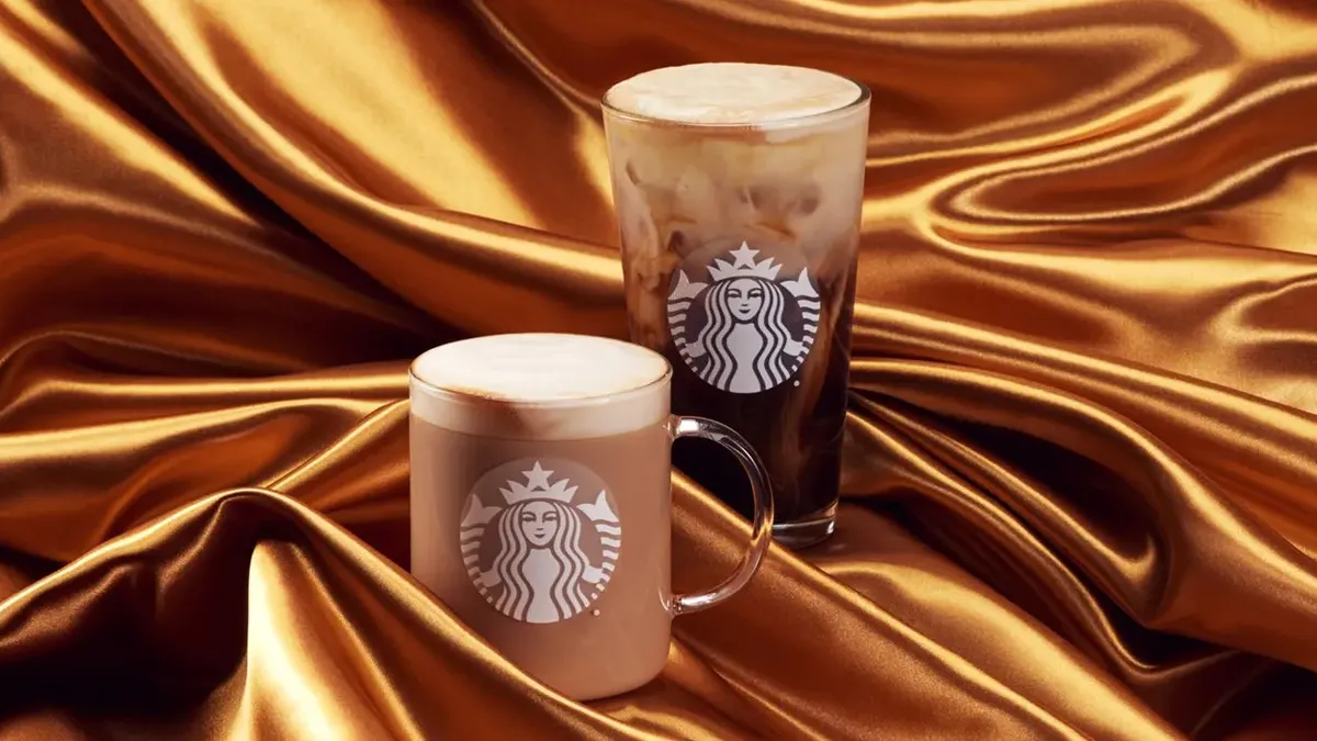 Starbucks Oleato beverages on a gold cloth.