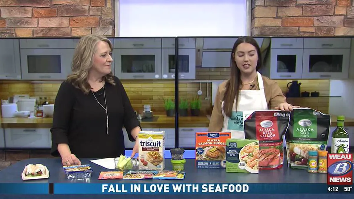 Two women promote seafood on the local news.