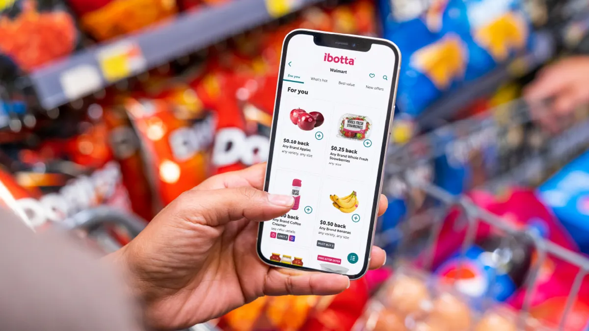 Phone in hand showing online shopping cart
