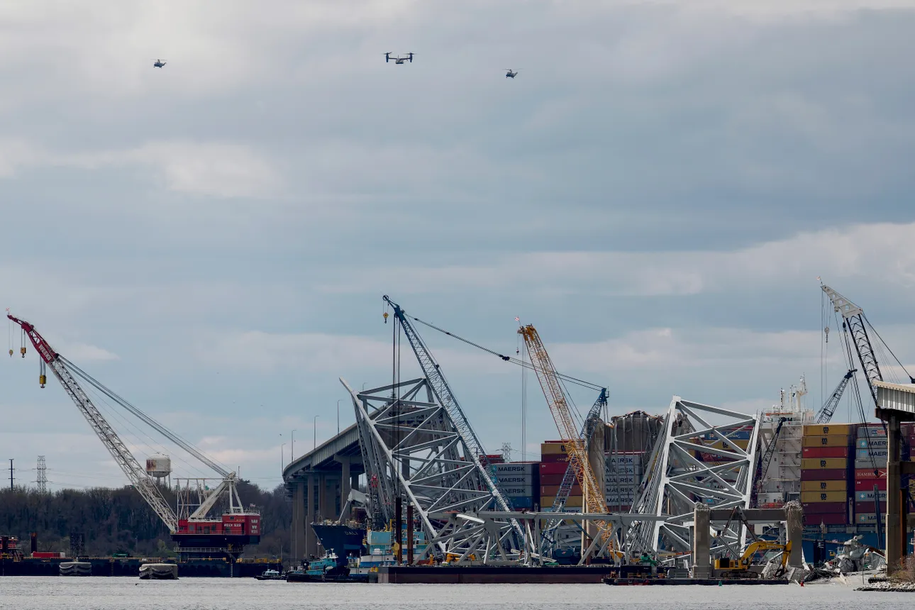 A fleet of helicopters, including Marine One carrying U.S. President Joe Biden, circles the site of the collapsed Francis Scott Key Bridge, on April 5, 2024 in Baltimore, Maryland.