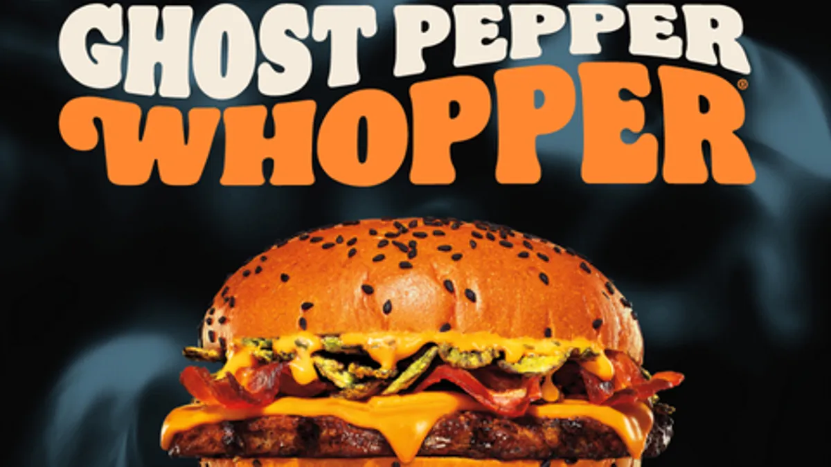 Burger King's new Ghost Pepper Whopper floating against a smoky black background and under large white-and-orange text that reads "Ghost Pepper Whopper."