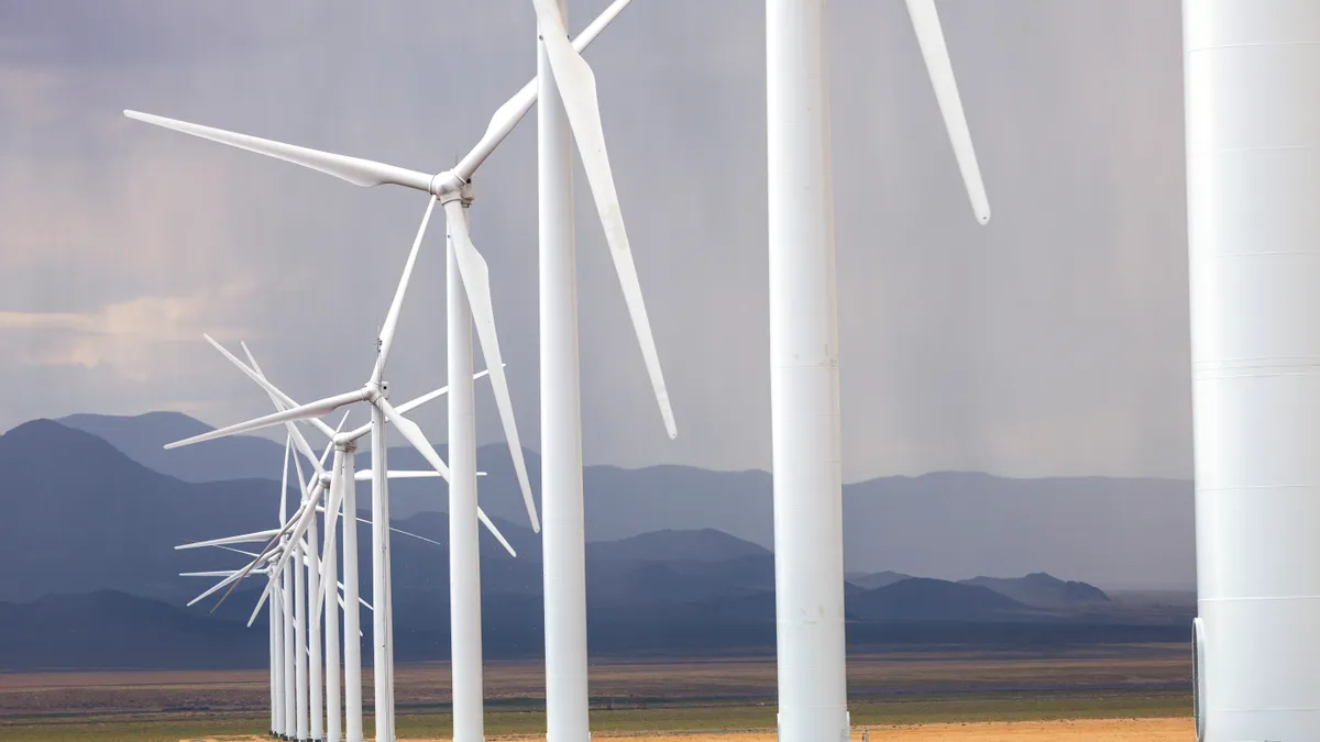 Wind turbines generate electricity during a thunderstorm in the central Utah desert.