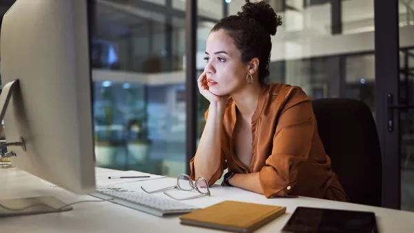 A person works on the computer in the office, late at night