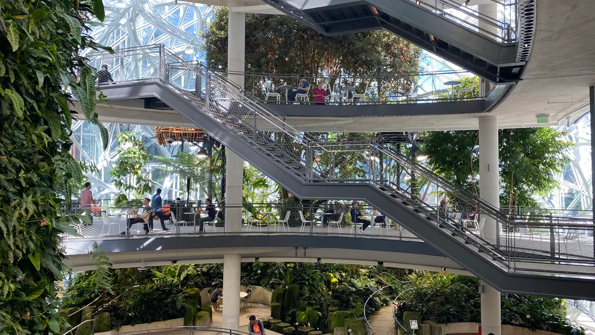 An open atrium filled with plants with stars crossing open floors.