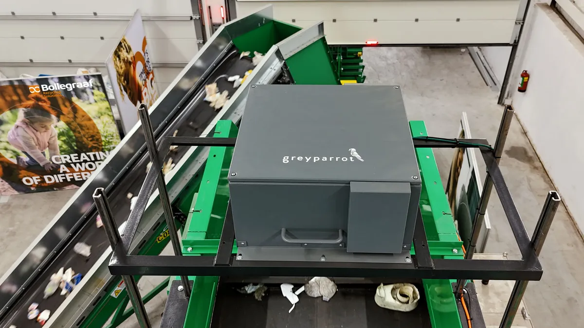 A Greyparrot Analyzer sits above a belt filled with recyclable materials at a Bollegraaf test center