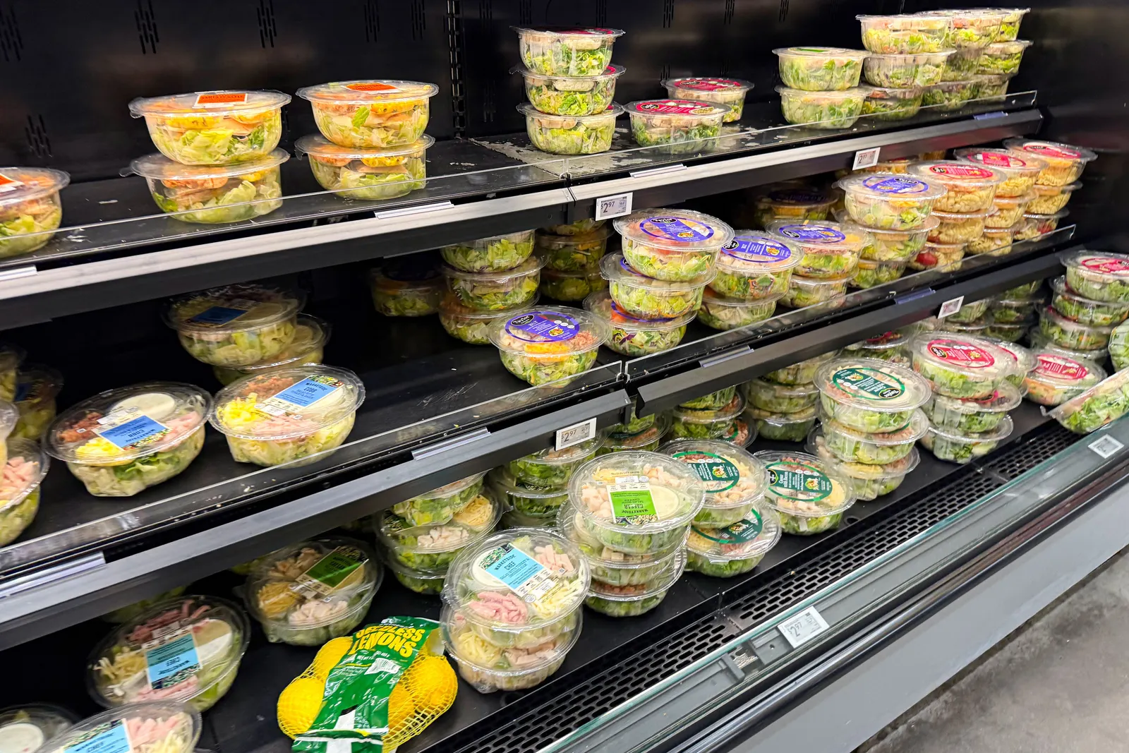 Prepackaged salad kits at a store.