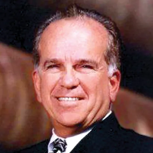 A headshot shows Ron Tutor, CEO of Tutor Perini.