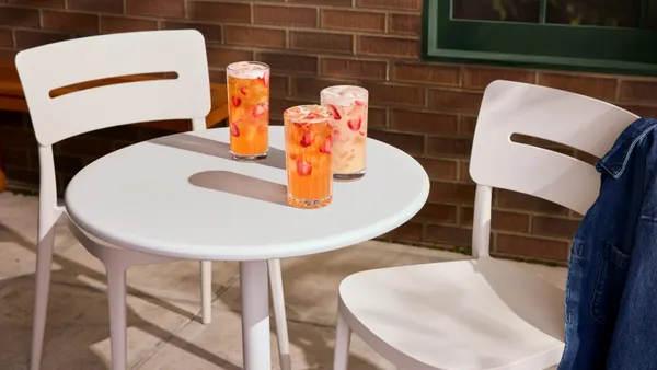 Three Starbucks mango strawberry refreshers on a table.