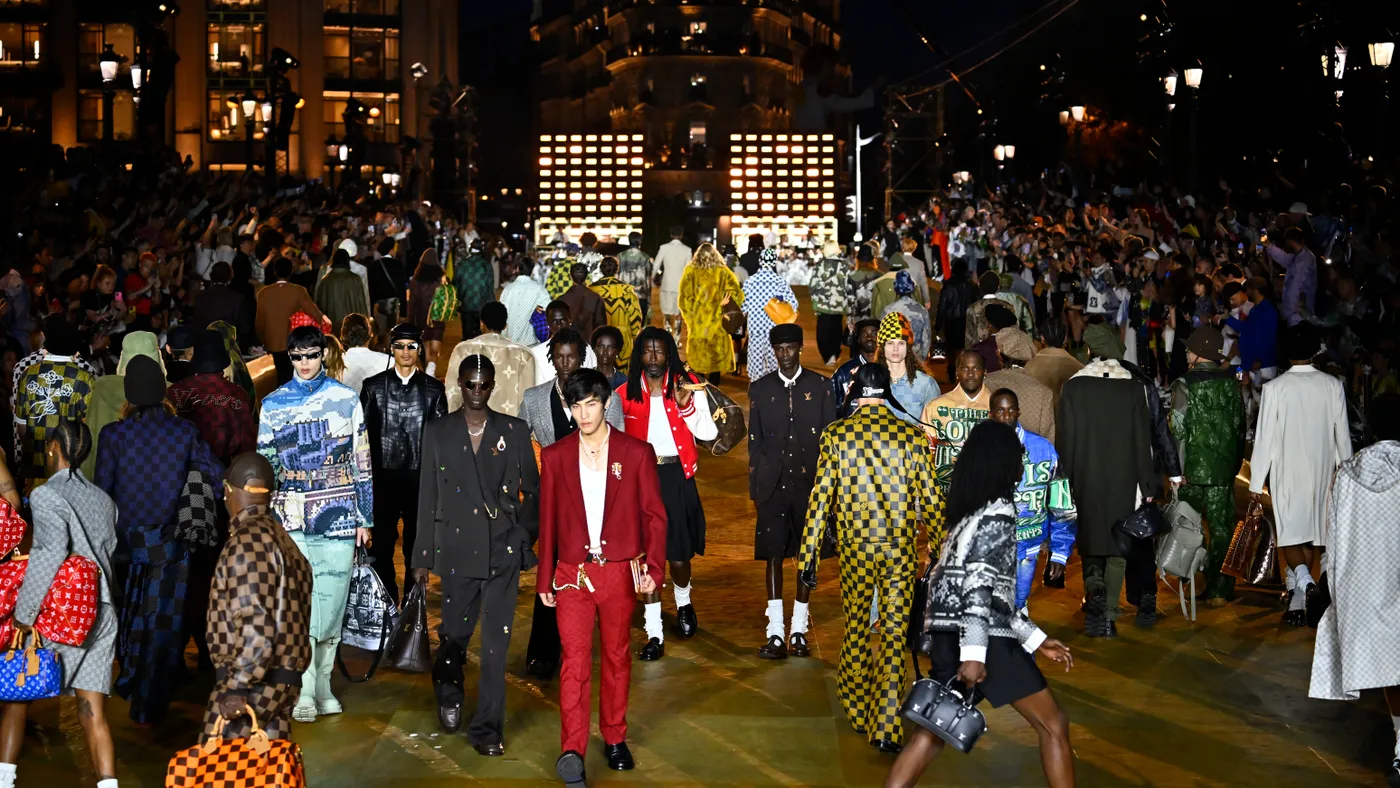 Models in colorful clothes walk the runway during the Pharrell Williams Louis Vuitton Menswear Spring/Summer 2024 show finale as part of Paris Fashion Week.