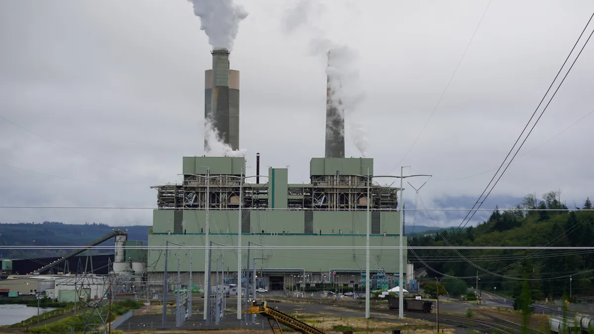 A power plant under a cloudy sky.