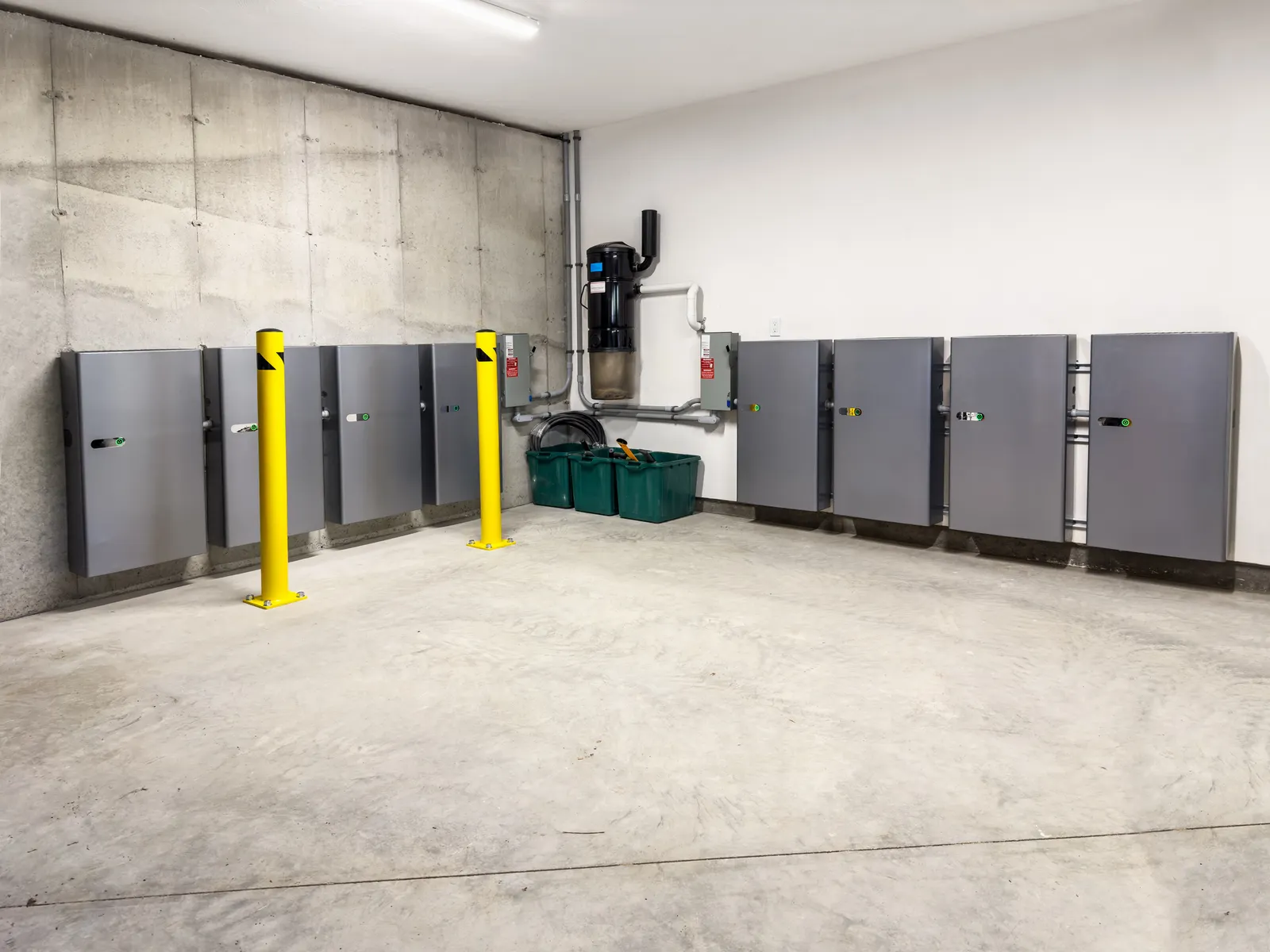 Storage batteries for solar power installed on a garage wall.