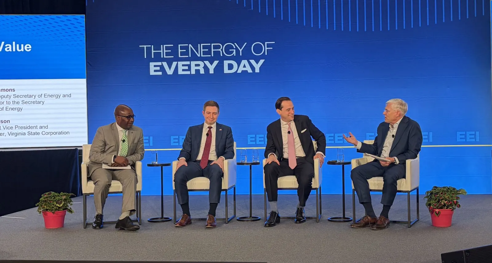 Four people on stage in front of a screen that reads "the energy of every day"