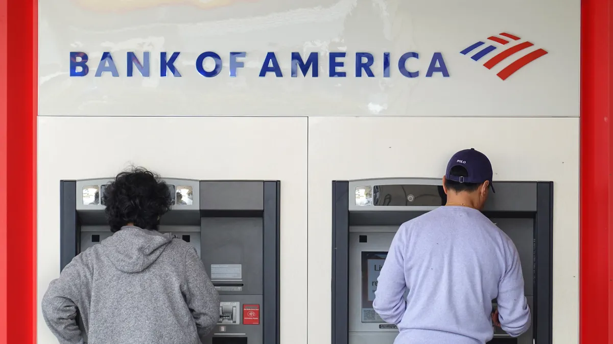 Customers use an ATM at a Bank of America office.