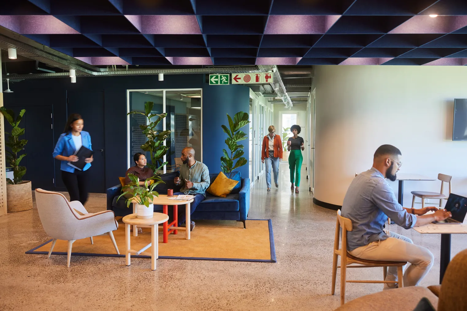 A group of worker in a lounge area of a modern office space.