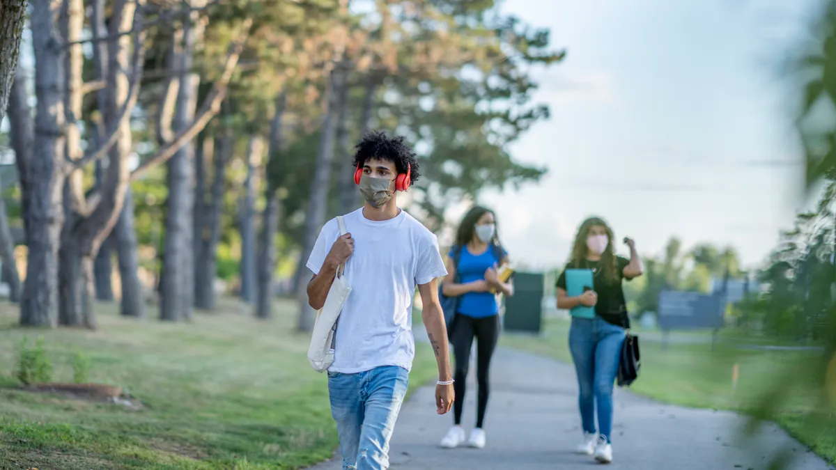 college students talking on campus wearing facemasks