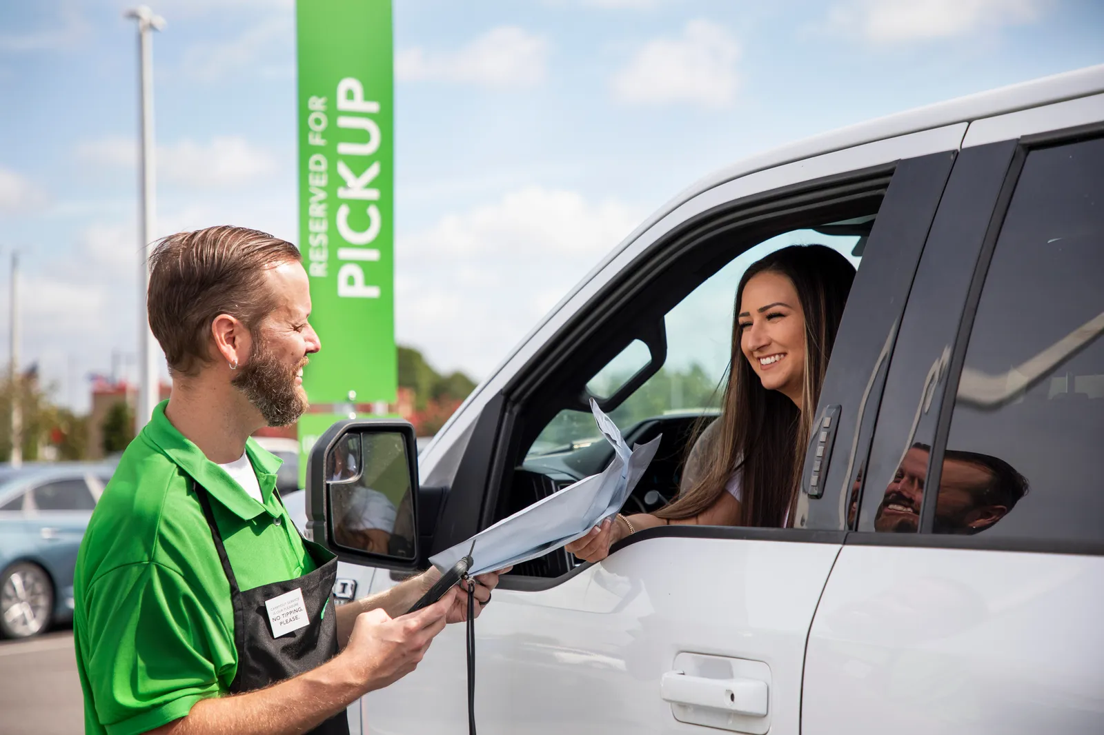 Publix employee delivering someone's pharmacy order to their car window