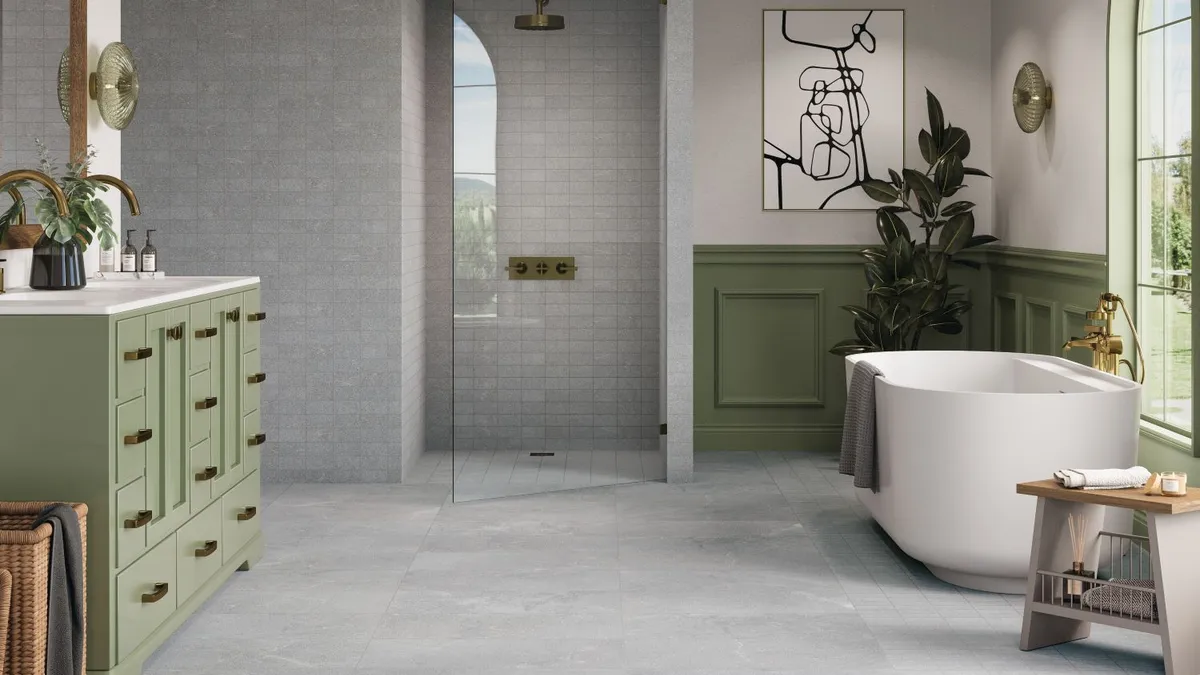 A bathroom with gray tile floors and walls.