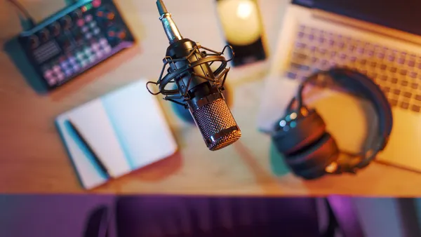 Professional audio equipment, notebook, laptop and smartphone on the desk in the home studio.
