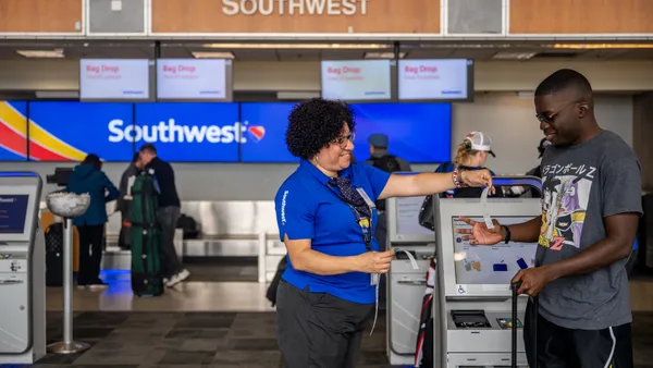 A Southwest Airlines employee assists a passenger.