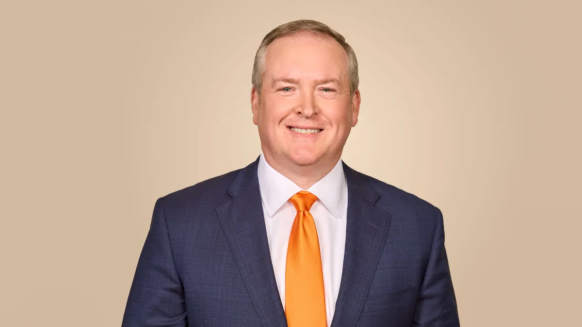 A professional headshot.